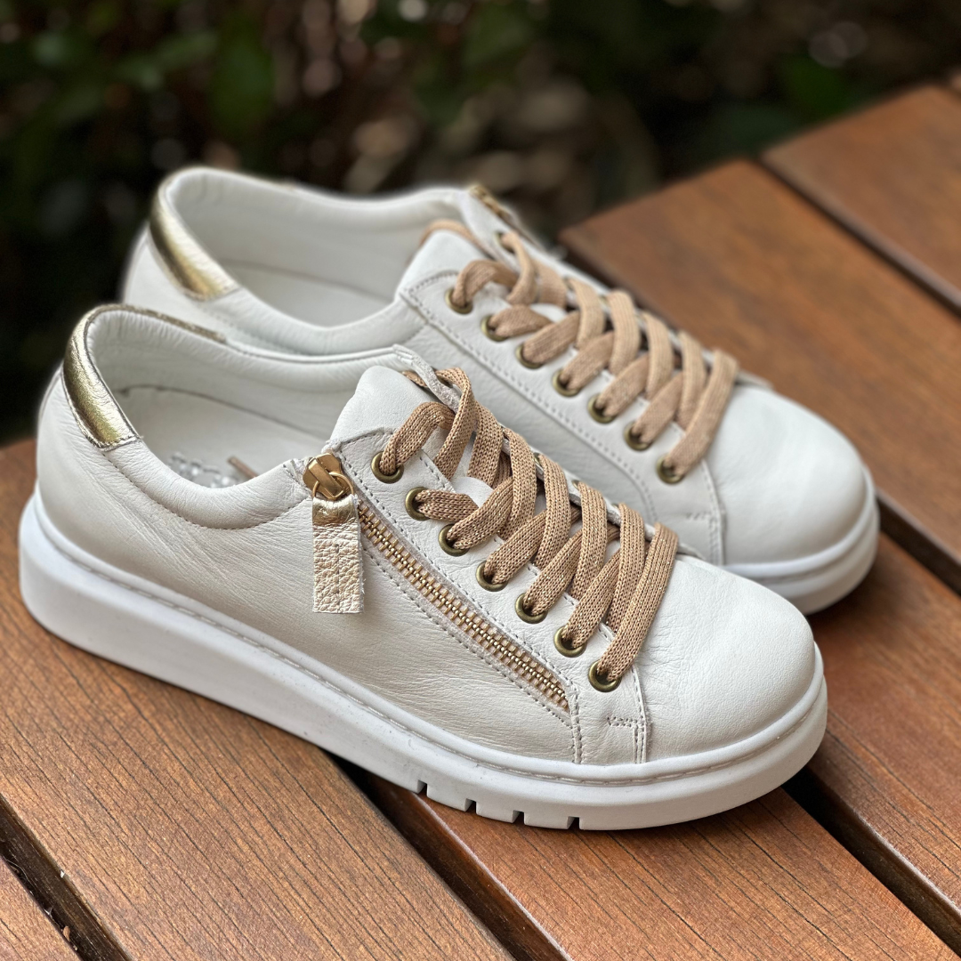 white sneakers with gold lace and side zip