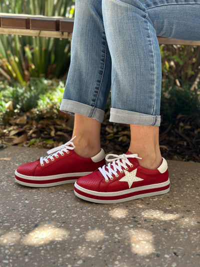 red womens sneakers with white star detail and platform soles