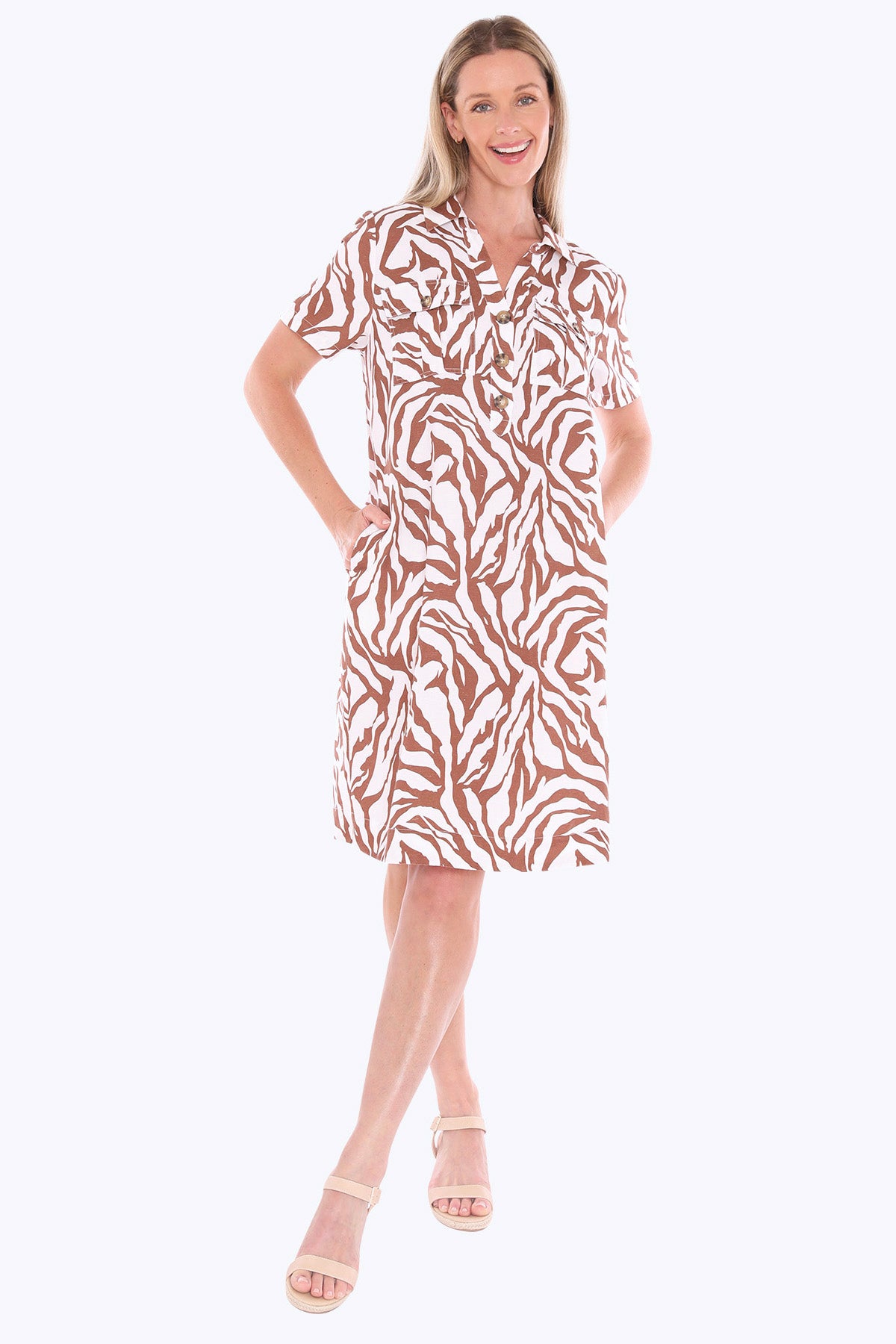 Woman wearing a patterned dress on a white background