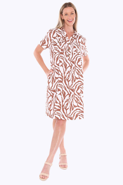 Woman wearing a patterned dress on a white background