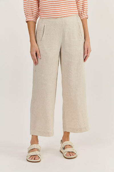 Person wearing beige wide-leg pants and a striped shirt on a plain background