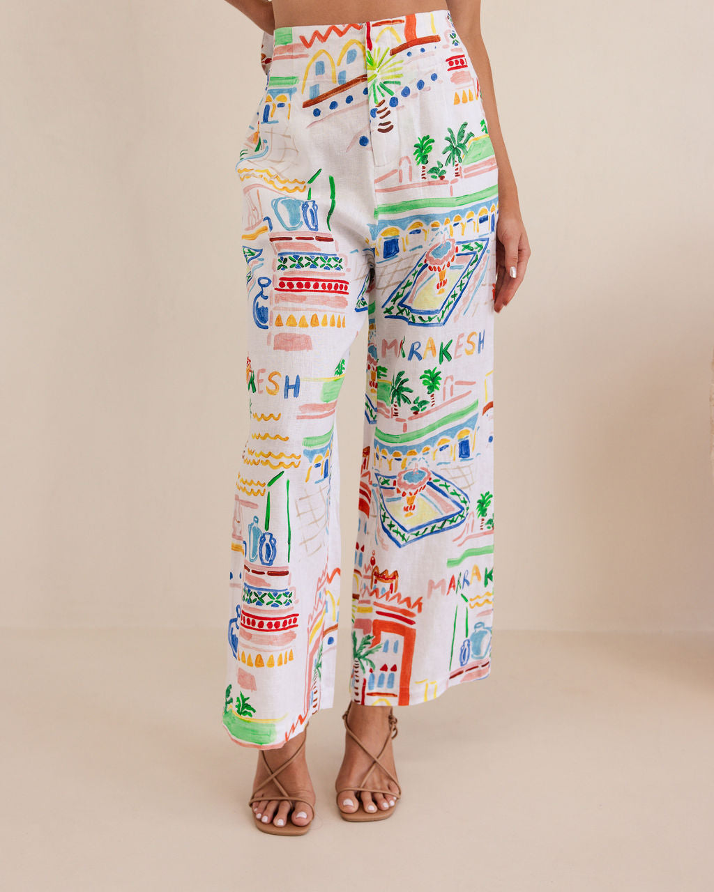 Colorful patterned pants worn by a person on a beige background