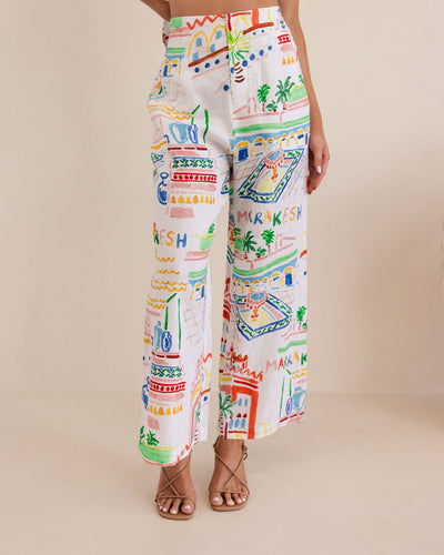 Colorful patterned pants worn by a person on a beige background