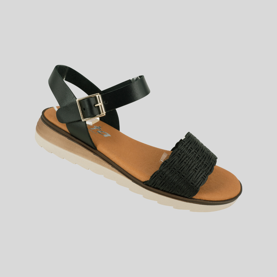 black low wedge sandal with textured leather on front panel and adjustable strap with buckle