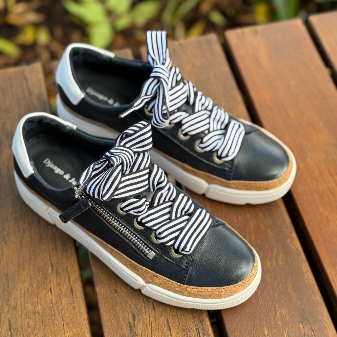 navy and white sneakers with white sole and striped laces