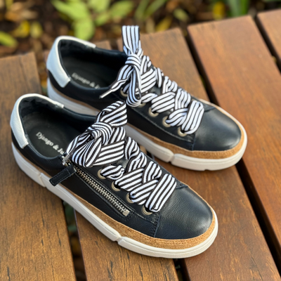 navy and white sneakers with white sole and striped laces