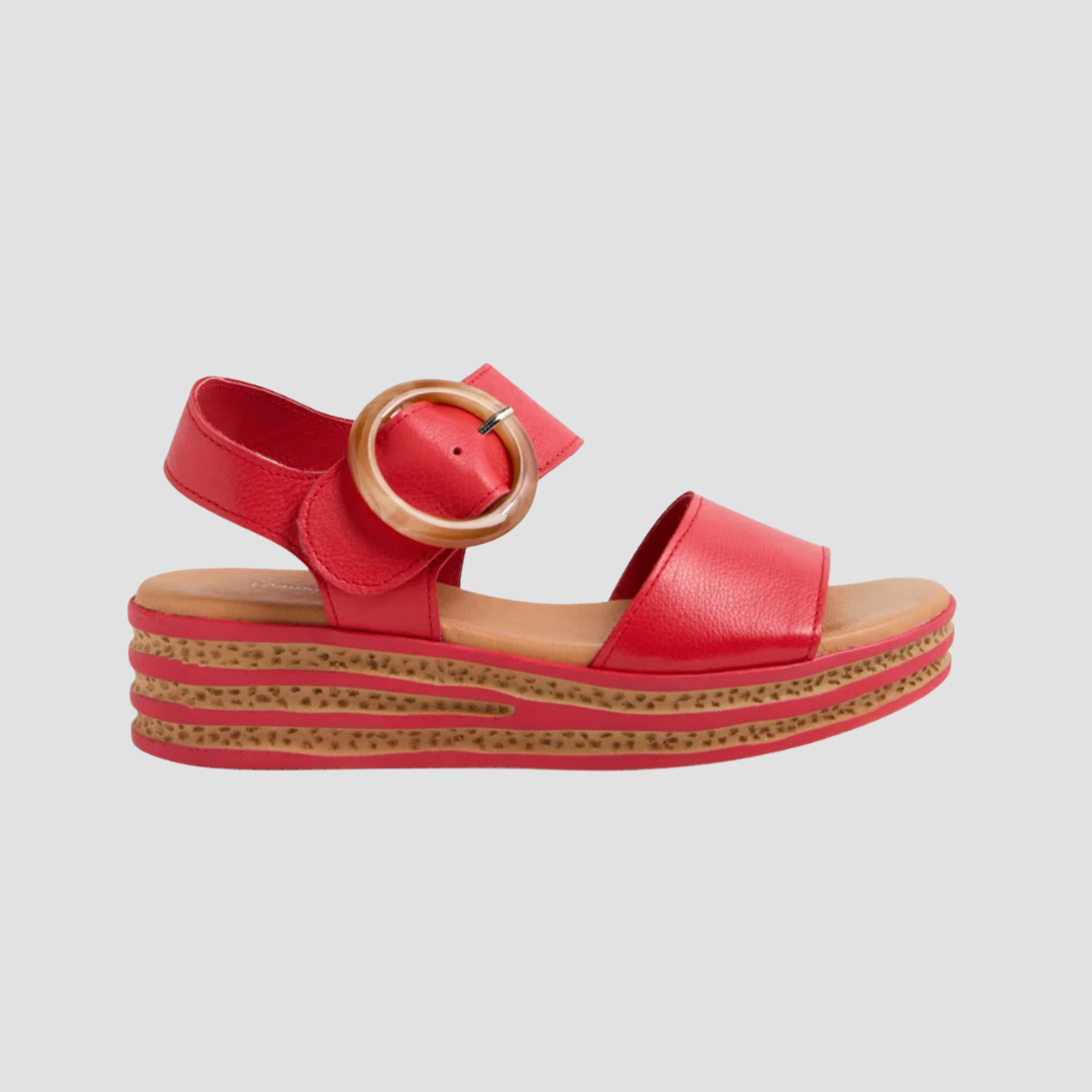 Red sandal with a velcro buckle on a light gray background