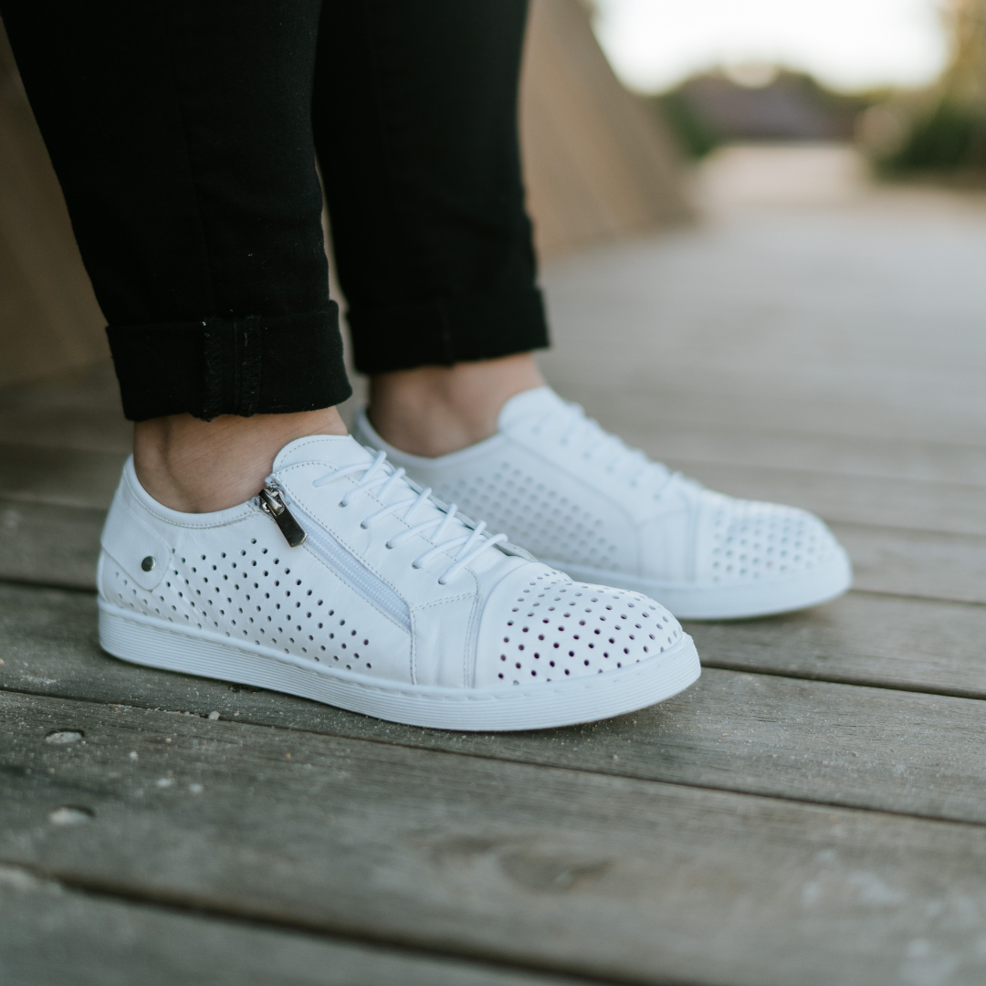 white soft punched leather sneakers with side zip. White soles and white shoe laces. Removable Innersoles