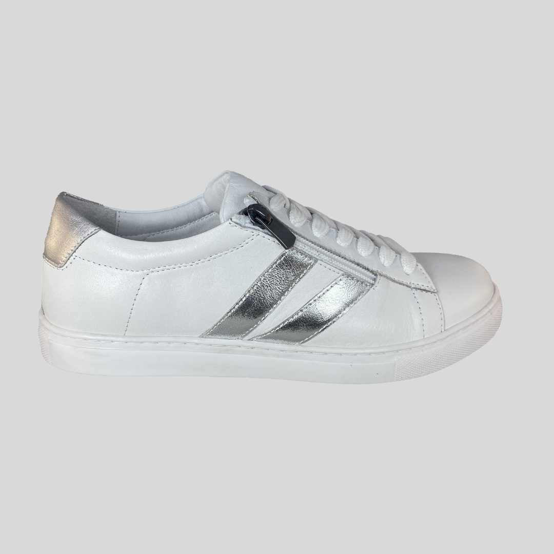 white leather sneakers with silver trim on side and at back of the heel. side zip making it easy to put on. Cushioned footbed which is removable for an orthotic
