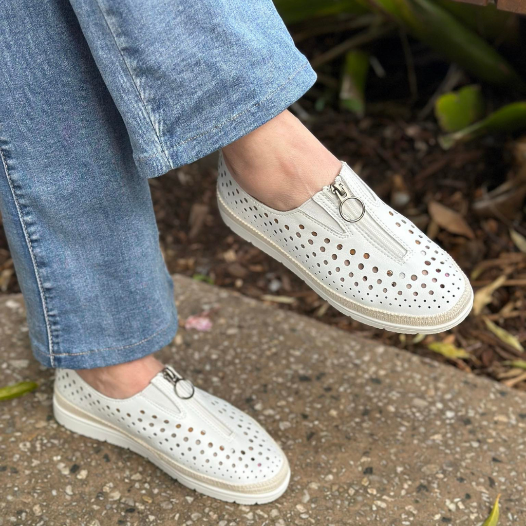 white leather slio on shoe with perforated holes