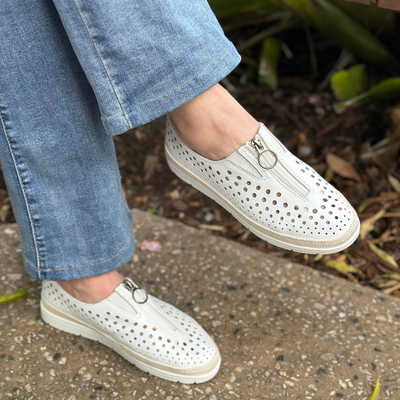 white leather slio on shoe with perforated holes