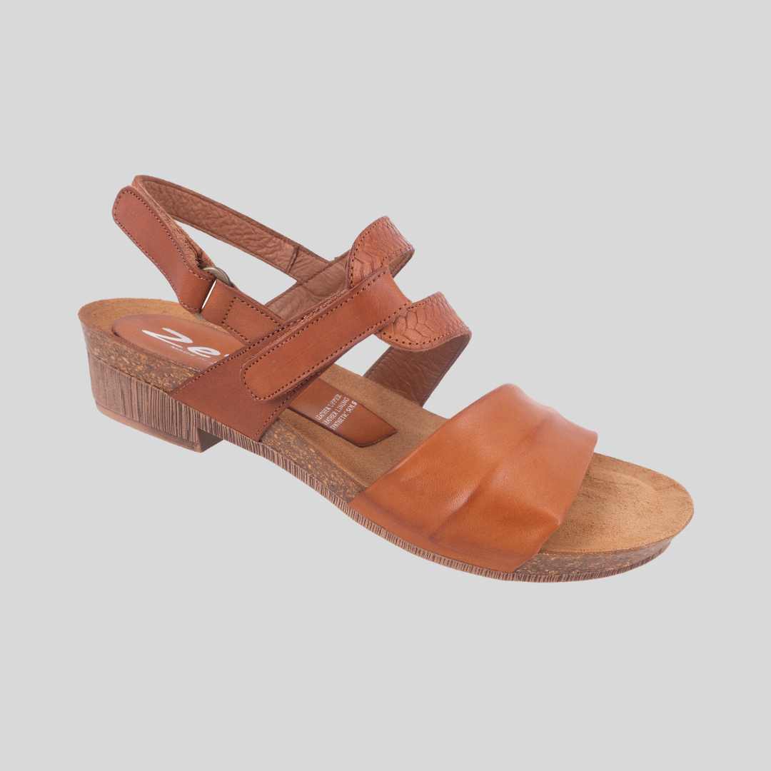 Tan sandal on a low heel with adjustable strap at instep and at heel