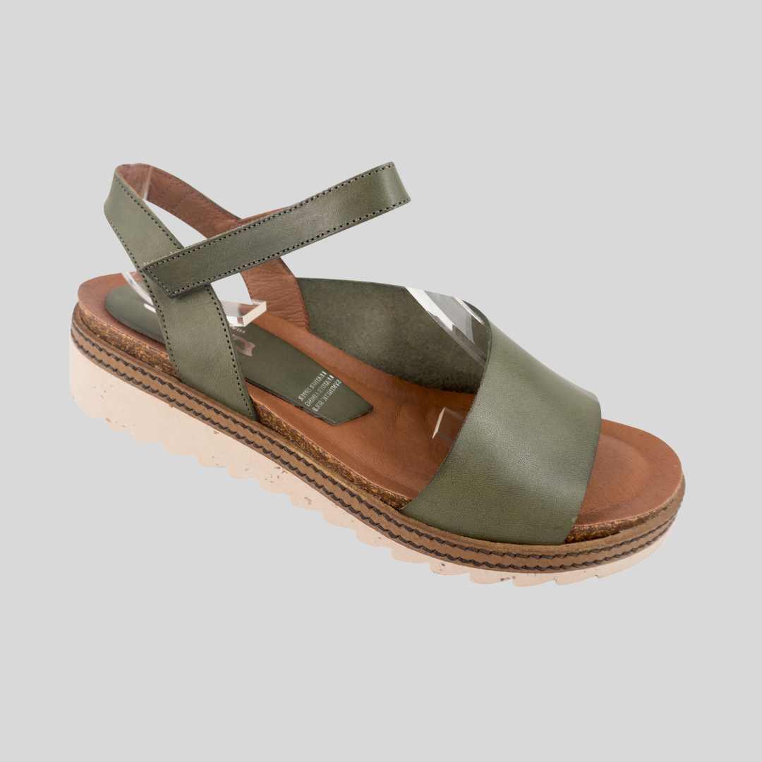 khaki sandal on a low wedge cream sole with adjustable velcro strap. 