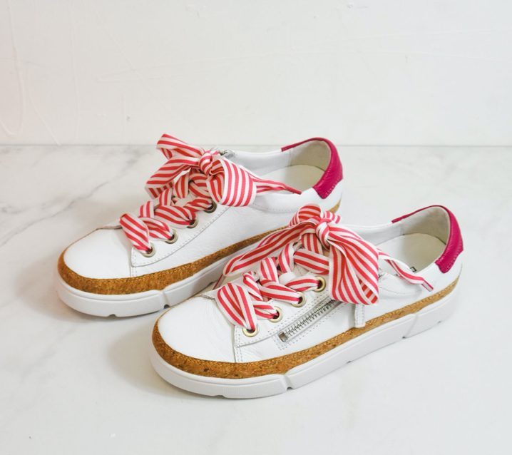 Django and juliette Torayne a white sneaker with hot pink trim and striped laces, side zip