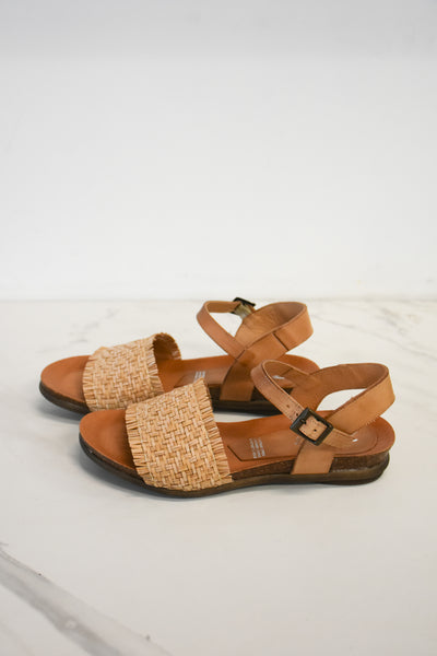 Neutral leatehr sandal with raffia panel across front of the foot